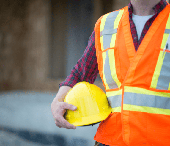 Construction worker in high-vis vest holding hard hat – symbolising Health and Safety Representative training in Perth