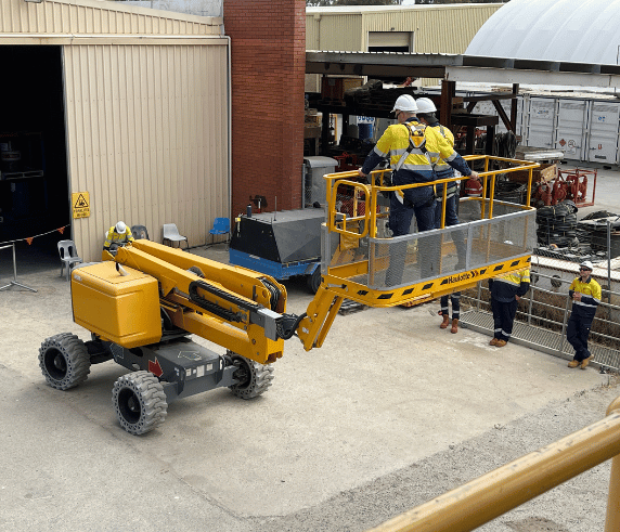 Three students at Safe rights training facility in Perth operating an EWP for the Advanced Rigging course.