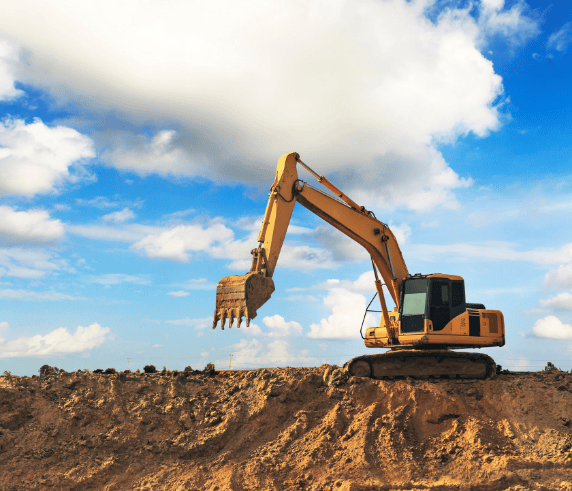 Earth moving Excavator on top of a dirt hill with clouds and blue sky in the background while doing Excavator Training course in Perth WA to Earn an Excavator Ticket.